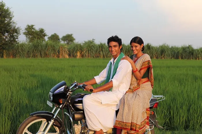 Framed Print : Indian rural couple riding on a motorcycle in the field Framed Print : Indian rural couple riding on a motorcycle in the field
