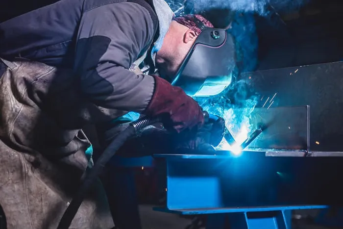 Framed Print : Industrial Welder With Torch and Protective Helmet in big hall welding metal profiles Framed Print : Industrial Welder With Torch and Protective Helmet in big hall welding metal profiles