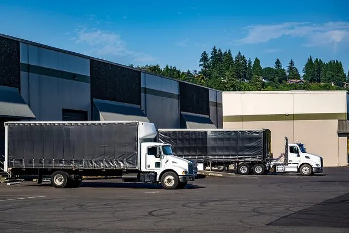 Framed Print : Industrial white day cab big rig semi trucks with conestoga flat bed semi trailer