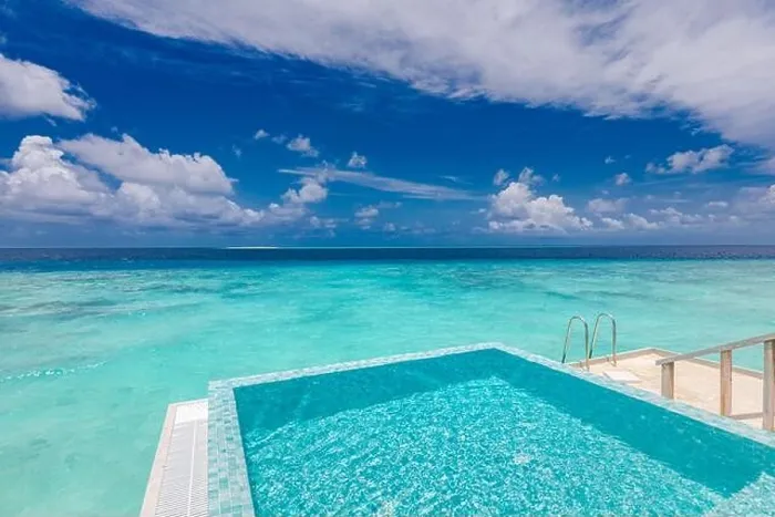 Framed Print : Infinity swimming pool with sea and ocean view on blue sky background. Luxury infinity pool over amazing turquoise lagoon and ladder into the water Framed Print : Infinity swimming pool with sea and ocean view on blue sky background. Luxury infinity pool over amazing turquoise lagoon and ladder into the water