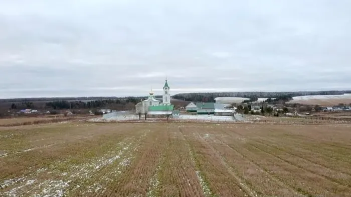 Framed Print : Initial winter. Clip.View from a drone on a landscape with snowy grass in a field where there is a temple with a golden