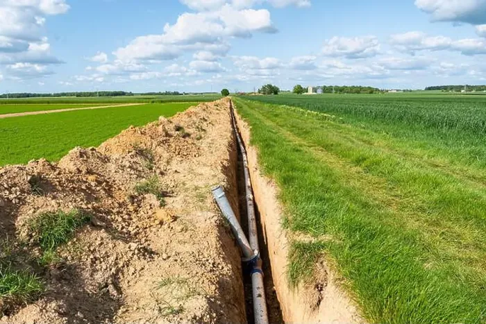 Framed Print : Installation of irrigation pipes, farm irrigation system. Buried pipes at the edge of a field, sprinkler system Framed Print : Installation of irrigation pipes, farm irrigation system. Buried pipes at the edge of a field, sprinkler system