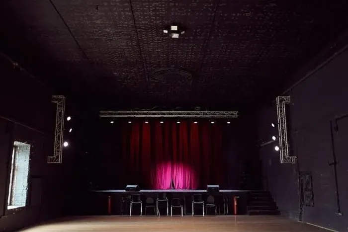 Framed Print : Interior of empty concert hall without chairs and small stage with purple curtains