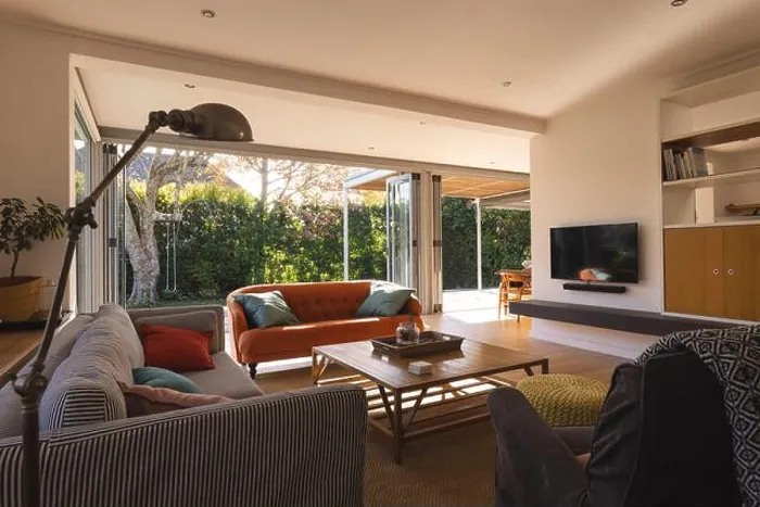 Framed Print : Interior of a living room with television, couch and armchair over big window and garden Framed Print : Interior of a living room with television, couch and armchair over big window and garden