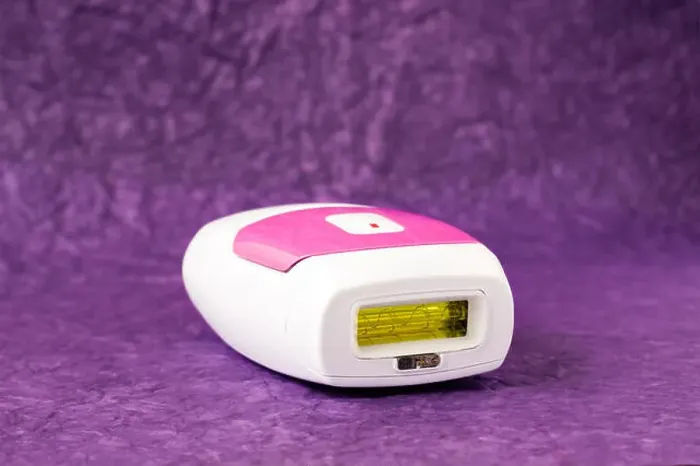Framed Print : IPL hair removal epilator on a purple background Framed Print : IPL hair removal epilator on a purple background