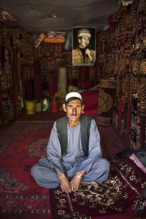 Framed Print : Ismaili Carpet seller with Aga Khan portrait carpet, in Ishkashim, Badakhshan, Afghanistan Framed Print : Ismaili Carpet seller with Aga Khan portrait carpet, in Ishkashim, Badakhshan, Afghanistan