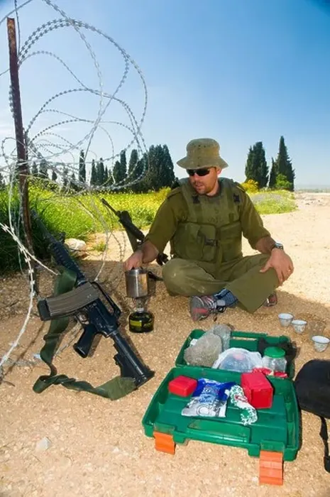 Framed Print : Israel West Bank Israeli reserve soldier preparing coffee at leisure during active duty Framed Print : Israel West Bank Israeli reserve soldier preparing coffee at leisure during active duty
