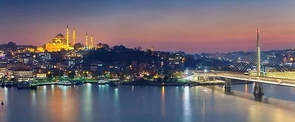 Istanbul Panorama. Panoramic image of Istanbul with Suleymaniye Mosque and Golden Horn Metro Bridge at sunset