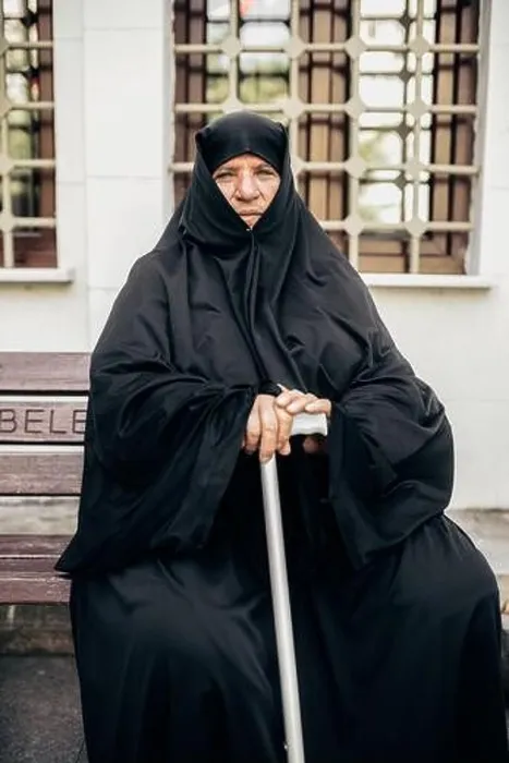 Framed Print : Istanbul, Turkey - June, 18 2018: Senior Muslim woman in hijab holding walking stick and looking at camera while sitting on bench Framed Print : Istanbul, Turkey - June, 18 2018: Senior Muslim woman in hijab holding walking stick and looking at camera while sitting on bench
