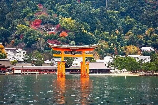 The Itsukushima Shrine Otorii Gate from the water at Miyajima Island, Hiroshima, Japan. (sign reads: Itsukushima Shrine)
