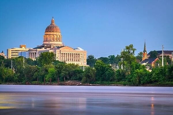 Jefferson City, Missouri, USA downtown view on the Missouri River with the State Capitol at dusk