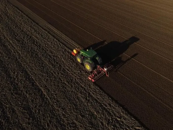 Framed Print : A John Deere Tractor seeds a previously cultivated field with sweetcorn, late in the evening Framed Print : A John Deere Tractor seeds a previously cultivated field with sweetcorn, late in the evening