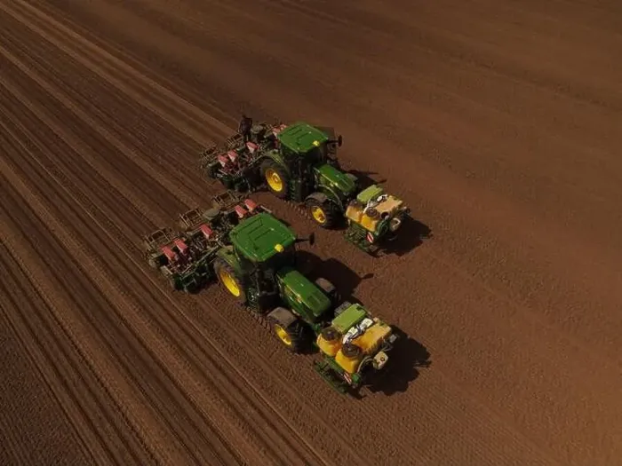 Framed Print : Two John Deere tractors, seen from above, work together to plant a field with sweetcorn after it has been cultivated Framed Print : Two John Deere tractors, seen from above, work together to plant a field with sweetcorn after it has been cultivated