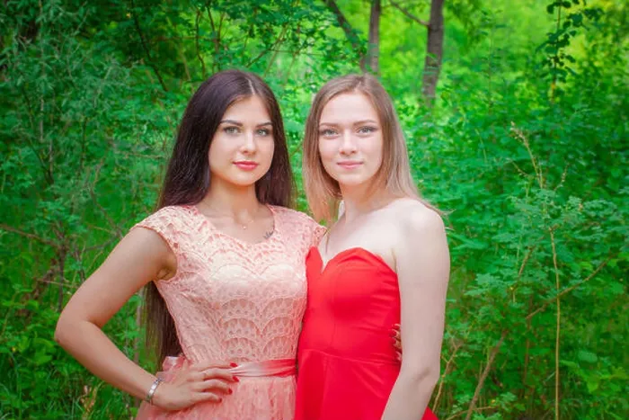 Framed Print : Joint portrait of two friends. Beautiful girls posing in beautiful dresses. Women against the backdrop of the forest Framed Print : Joint portrait of two friends. Beautiful girls posing in beautiful dresses. Women against the backdrop of the forest