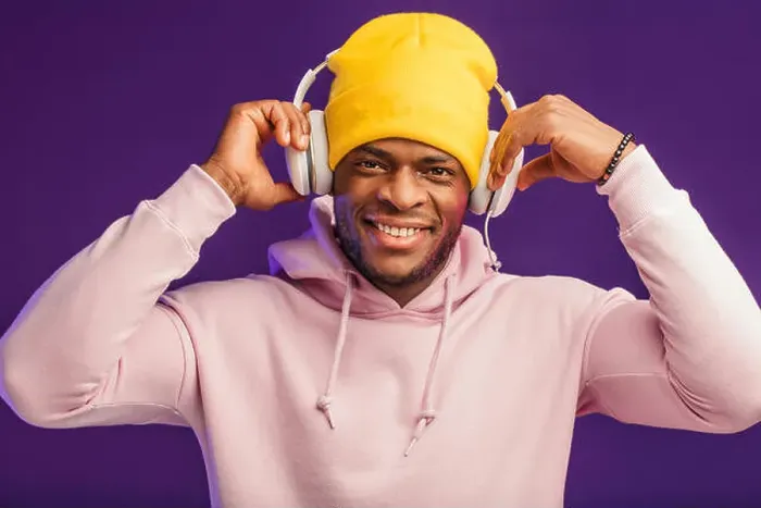 Framed Print : Joyful happy hipster man in white hoodie and yellow hat listening music with headphones Framed Print : Joyful happy hipster man in white hoodie and yellow hat listening music with headphones