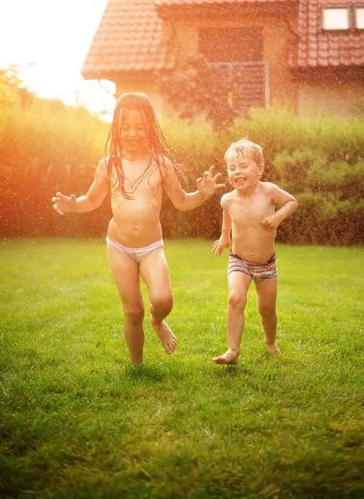 Framed Print : Joyful kids enjoying the summer shower in the garden Framed Print : Joyful kids enjoying the summer shower in the garden