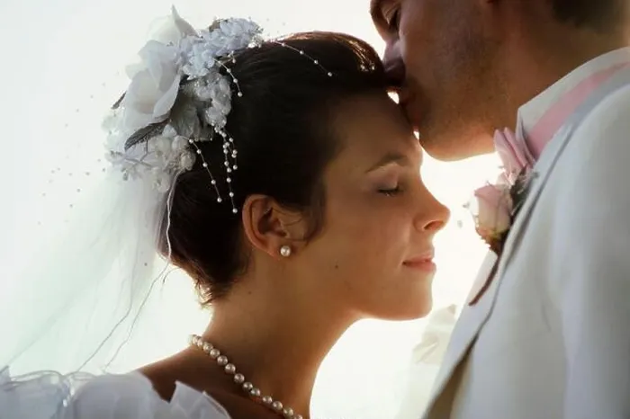 Framed Print : Just married, new Caucasian husband kisses his beautiful young wife on the forehead Framed Print : Just married, new Caucasian husband kisses his beautiful young wife on the forehead