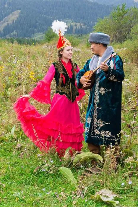 Framed Print : Kazakh man singing and playing dombra for a woman Framed Print : Kazakh man singing and playing dombra for a woman