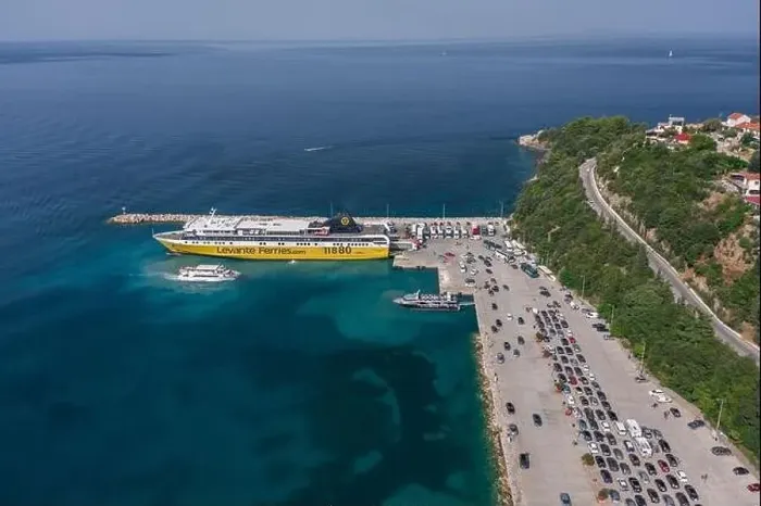 Framed Print : Kefalonia, Greece - August 22, 2019: Aerial drone shot of cars in queue for embarkement in cruise ship in Poros Framed Print : Kefalonia, Greece - August 22, 2019: Aerial drone shot of cars in queue for embarkement in cruise ship in Poros