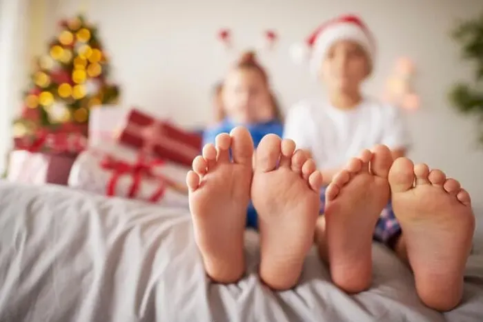 Framed Print : Kids feet in the bed at Christmas
