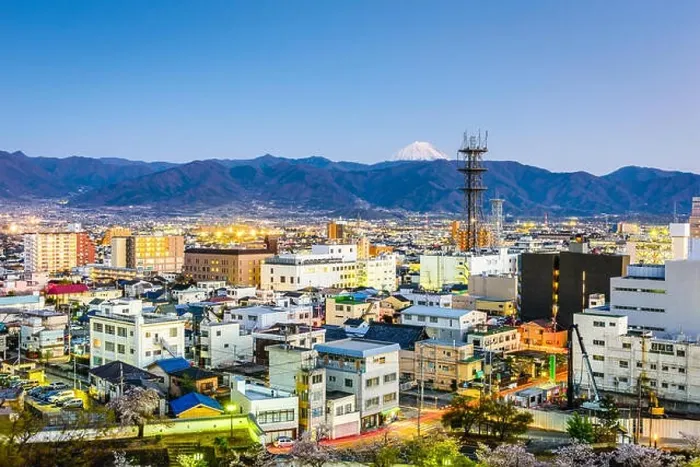 Framed Print : Kofu, Japan city skyline with Mt. Fuji peaking over the mountains Framed Print : Kofu, Japan city skyline with Mt. Fuji peaking over the mountains