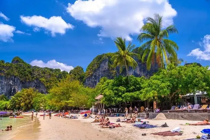 Framed Print : KRABI, THAILAND- MARCH 2018: People sunbathing among coconut palms on Railay beach west, Ao Nang, Krabi, Thailand Framed Print : KRABI, THAILAND- MARCH 2018: People sunbathing among coconut palms on Railay beach west, Ao Nang, Krabi, Thailand