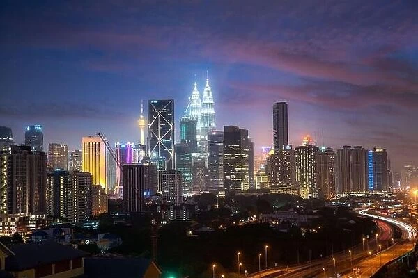 Kuala Lumpur City skyline and skyscraper with highway road at night in Kuala Lumpur, Malaysia. Asia. Malaysia tourism, modern city life, or business f