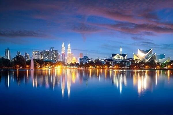 Kuala Lumpur city skyscraper and fountation with nice sky twilight at Titiwangsa Park in Kuala Lumpur. Malaysia. Travel and Vacation concept