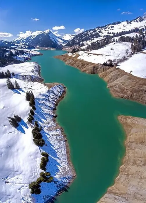 Framed Print : Lac de l'Hongrin is a reservoir in Vaud, Switzerland. Snowy mountain peaks surround the high alpine man made lake Framed Print : Lac de l'Hongrin is a reservoir in Vaud, Switzerland. Snowy mountain peaks surround the high alpine man made lake