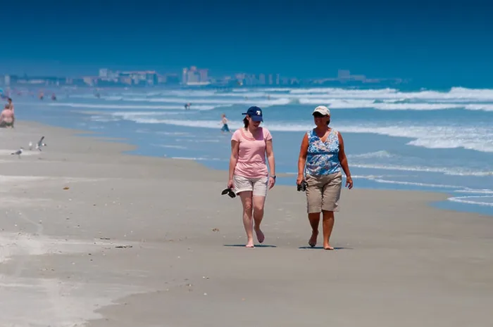 Framed Print : Two ladies walking along the Cocoa beach In Florida Framed Print : Two ladies walking along the Cocoa beach In Florida