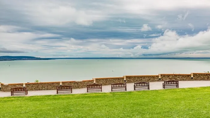 Framed Print : Lakeside bench at october indian summer, overcast sky, tranquil nature, mountain view background Framed Print : Lakeside bench at october indian summer, overcast sky, tranquil nature, mountain view background