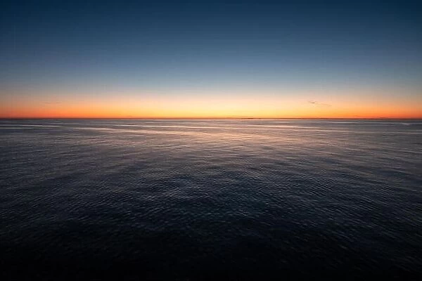 Empty landscape with calm sea and scenic sunset in Gulf of Finland