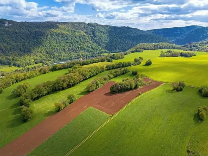 Framed Print : Landscape with fields, mountains and river in France near Besancon in spring, Franche-Comte Framed Print : Landscape with fields, mountains and river in France near Besancon in spring, Franche-Comte
