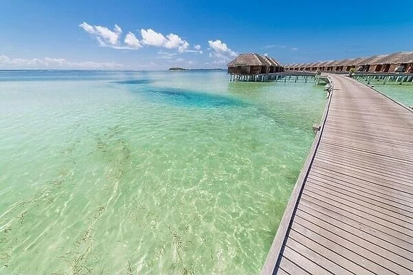 landscape of Maldives beach. Tropical panorama, luxury water villa resort with wooden pier jetty. Luxury travel destination background summer vacation
