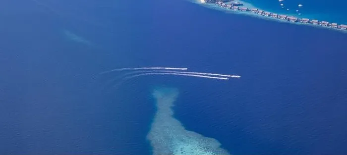 Framed Print : Landscape seascape aerial view over Maldives luxury resort villas with atoll sandbank island. Jet skis having fun in ocean lagoon. Luxurious summer Framed Print : Landscape seascape aerial view over Maldives luxury resort villas with atoll sandbank island. Jet skis having fun in ocean lagoon. Luxurious summer