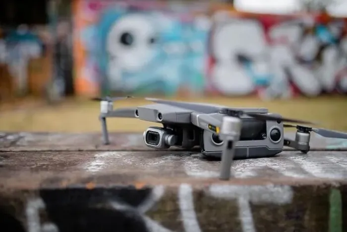 Framed Print : Landscape View of a Gray Drone with A Blurry Graffiti Wall in the Background Framed Print : Landscape View of a Gray Drone with A Blurry Graffiti Wall in the Background