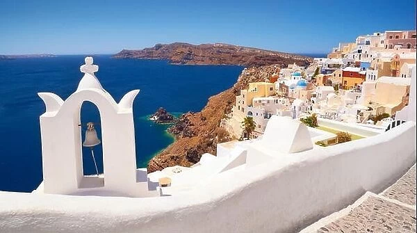Landscape with white greek bell tower and sea in the background - Oia Town, Santorini Island, Cyclades, Greece