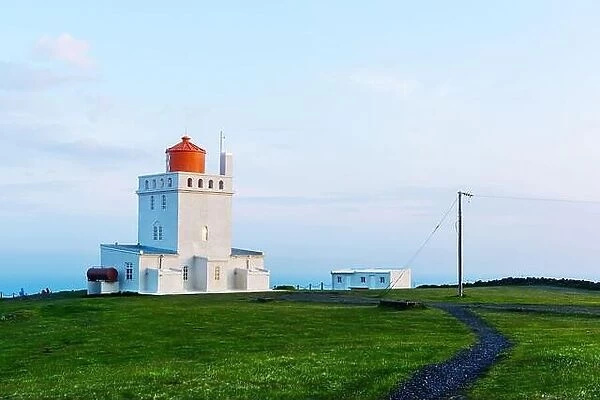 Landscape with white lighthouse at Cape Dyrholaey, located on south coast of Atlantic ocean in Iceland