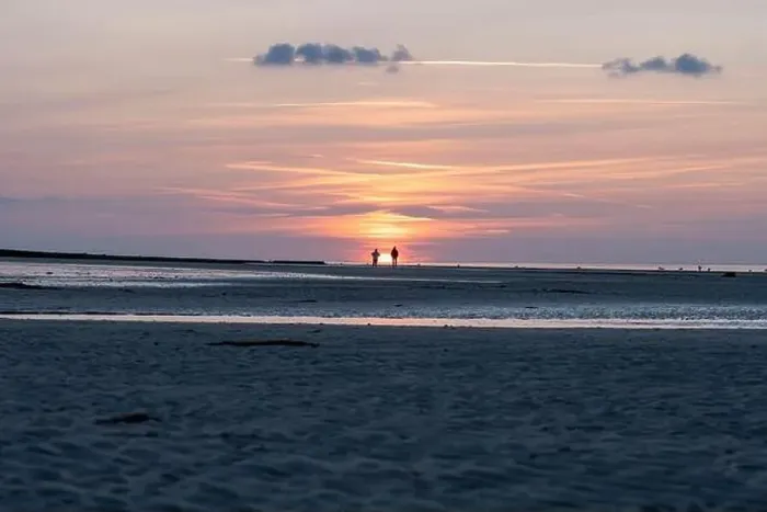 Framed Print : Langrune-Sur-Mer, France - 07 21 2023: View a man and a woman looking at the sunset on the beach Framed Print : Langrune-Sur-Mer, France - 07 21 2023: View a man and a woman looking at the sunset on the beach