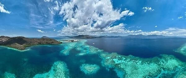 A large fringing reef grows along the edge of a remote island near Alor, Indonesia. This beautiful region is known for its high marine biodiversity