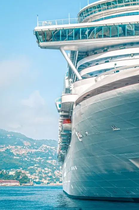 Framed Print : Front detail of large luxury cruise ship in clear blue water with city in background. Comfortable cruise or voyage Framed Print : Front detail of large luxury cruise ship in clear blue water with city in background. Comfortable cruise or voyage