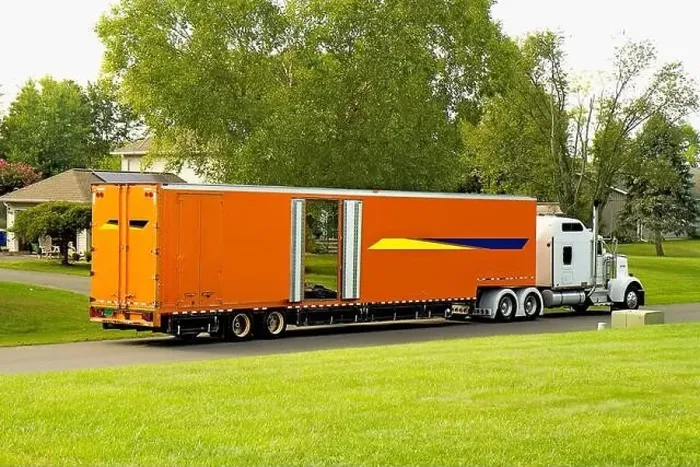 Framed Print : Large Orange Moving Truck out front of a neighborhood home while loading the owner's household item Framed Print : Large Orange Moving Truck out front of a neighborhood home while loading the owner's household item