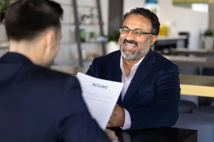 Framed Print : Laughing older Indian male applicant passing job interview successfully Framed Print : Laughing older Indian male applicant passing job interview successfully