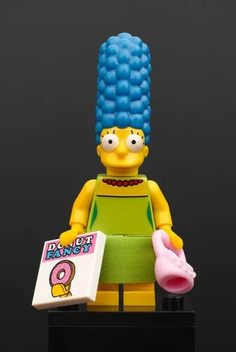 Framed Print : Lego Marge Simpson minifigure with pink purse and magazine Donut Fancy on black background Framed Print : Lego Marge Simpson minifigure with pink purse and magazine Donut Fancy on black background