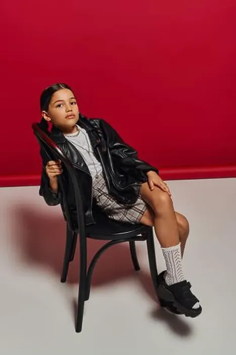 Framed Print : Full length of fashionable preteen girl with hairstyle posing in leather jacket Framed Print : Full length of fashionable preteen girl with hairstyle posing in leather jacket