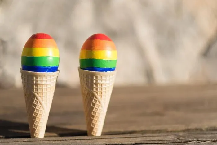 Framed Print : Lgbt couple family. Eggs with lgbt flag color in ice cream waffle cone on nature spring outdoor background Framed Print : Lgbt couple family. Eggs with lgbt flag color in ice cream waffle cone on nature spring outdoor background