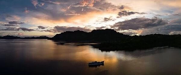 The last light of day illuminates clouds drifting above remote islands in the Solomon Islands. This country is home to high marine biodiversity