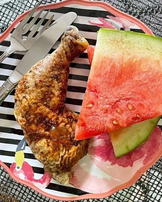 Framed Print : A light summer meal of fried chicken and watermelon slices on a festive black and white striped plate, USA Framed Print : A light summer meal of fried chicken and watermelon slices on a festive black and white striped plate, USA