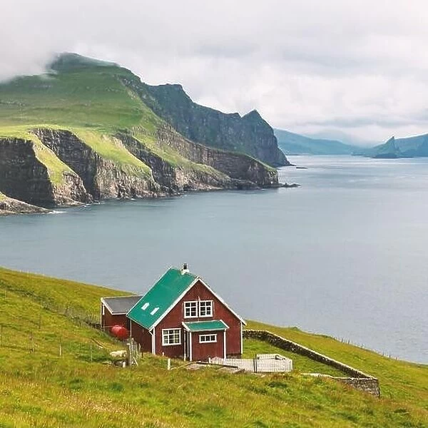 Lighthouse keeper's house on the Mykines island, Faroe islands, Denmark. Landscape photography