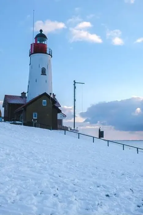 Framed Print : Lighthouse of Urk with snow landscape during winter in the Netherlands Framed Print : Lighthouse of Urk with snow landscape during winter in the Netherlands